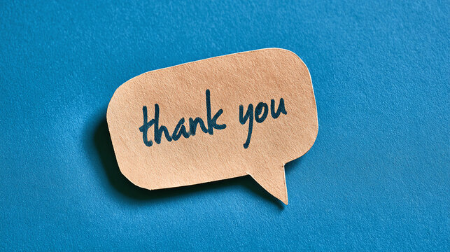 Thank you message on paper speech bubble note against blue background top