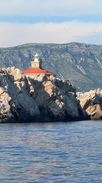 Grebeni Lighthouse on the Grebeni Islets near Dubrovnik in Croatia on the Adriatic Sea. Historic maritime navigation landmark guiding vessels along the Dalmatian coast.
