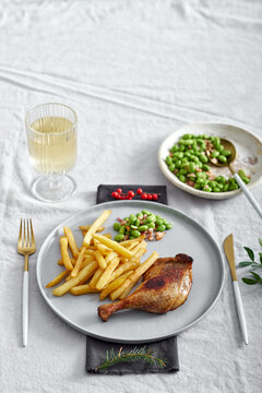 Roasted duck leg confit with french fries and edamame