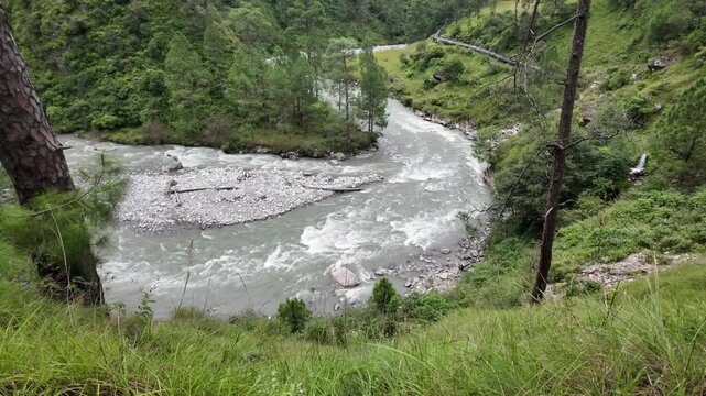 Fast Flowing Garhwal Himalayan River Through Forested Mountain Valley in Uttarakhand