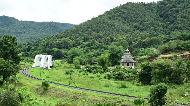 Lamphun, Thailand September 21, 2026 A State Railway of Thailand (SRT) train operating on the Bangkok&ndash;Chiang Mai route passes over the Tha Chomphu Bridgealso known as the White Bridgeat 1045 AM