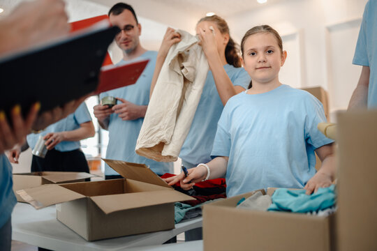 Volunteers sorting clothing donations for charity community service