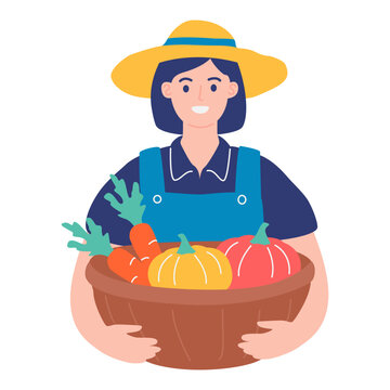 Smiling female farmer holding wooden basket of fresh autumn vegetables, organic gardening and harvest concept