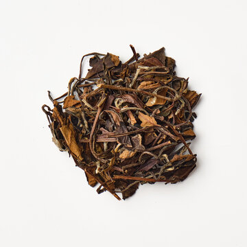 Dried oolong tea leaves on white background
