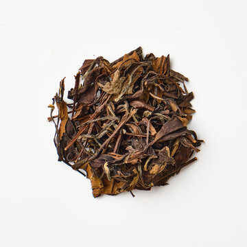 Dried herbal tea leaves on white background