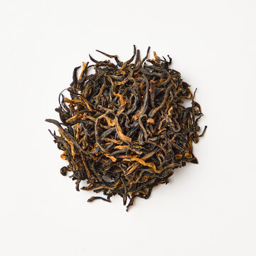 Dried loose leaf tea on white background