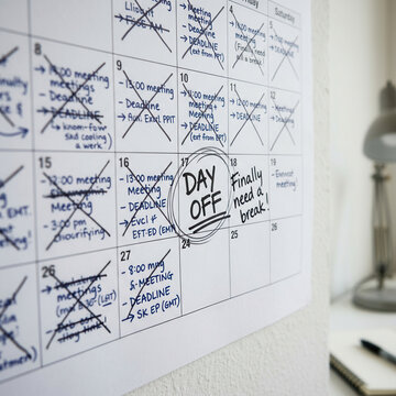 Calendar Marked With Busy Schedule And A Circle For Day Off