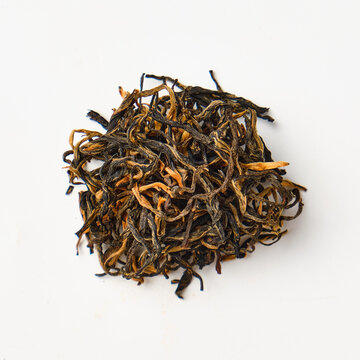 Dried loose leaf tea on white background