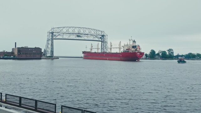 A massive cargo ship leaving Duluth through the aerial bridge on Lake Superior.