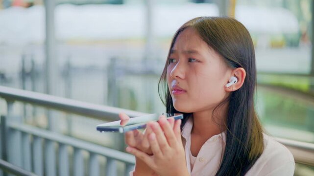 woman talking and command an AI voice assistant on a smartphone as a conceptual backdrop for artificial intelligence technology communication phone innovation virtual assistant and smart lifestyle