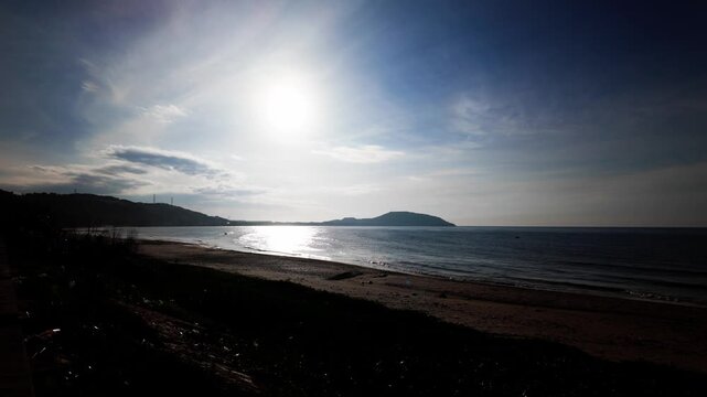 Explore the beautiful coastal area of Xuan Thuy in Mui Ne, Lam Dong. Enjoy the clear water and sandy beach as the sun shines brightly. People relax and spend time outdoors.
