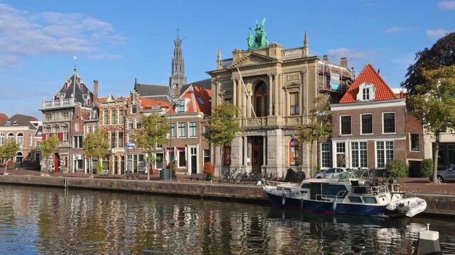 Spaarne river canal view showing classical Teylers Museum facade and St. Bavo church tower in Haarlem, Netherlands on 16 August 2026.