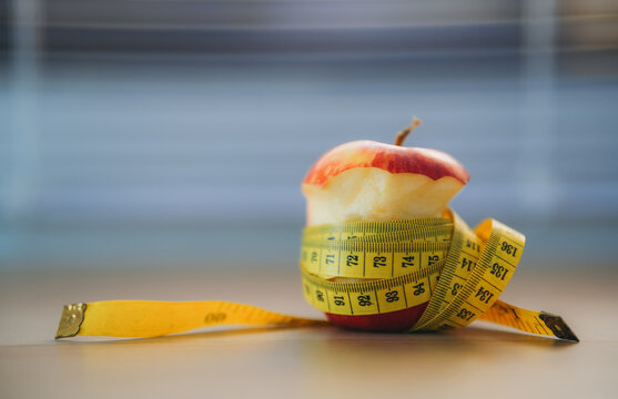 Apple with Measuring Tape Representing Healthy Diet, Weight Loss, Fitness, Nutrition, Slim Lifestyle and Fresh Fruit for Health and Wellness Concepts