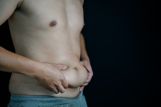 Young Man Experiencing Stomach Pain Holding His Abdomen, Male Health and Digestive Problem Concept