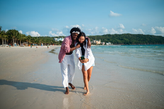Pure happiness. A young diverse, multiethnic couple enjoys every moment of their tropical getaway