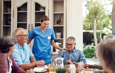 Obraz na płótnie Canvas Smile, caregiver and old people at house with food, assistance and social gathering for tea party. Happy, nurse or senior friends in dining room with snack, assisted living and sweet treat for health