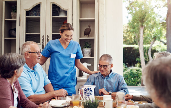 Smile, caregiver and old people at house with food, assistance and social gathering for tea party. Happy, nurse or senior friends in dining room with snack, assisted living and sweet treat for health