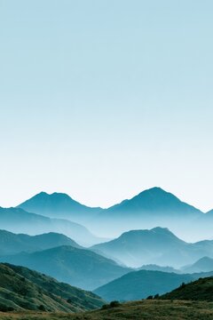 Layered Blue Mountain Ridges in Morning Haze Landscape