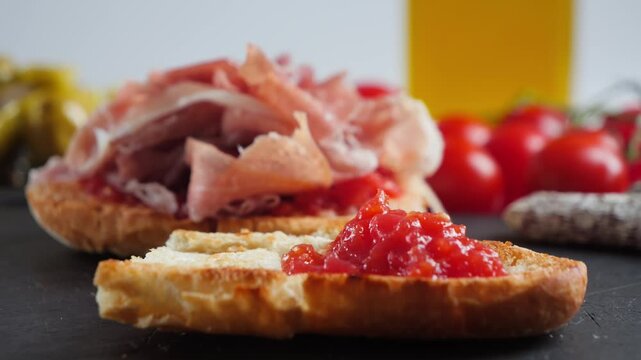 Grated tomato being spread onto toasted bread, preparing a traditional Spanish pan con tomate.
