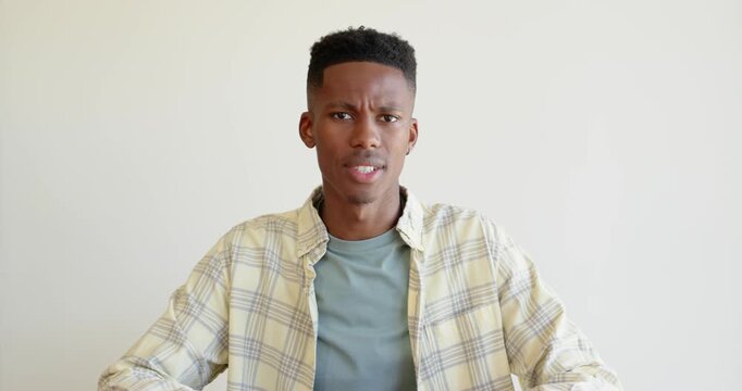 Close up of people talking to the camera, young man sitting and looking at camera, wearing casual pl