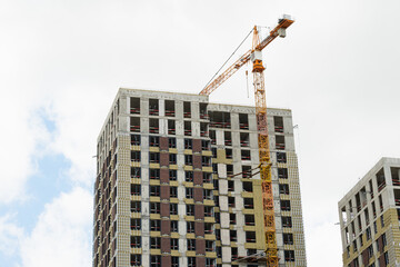 Residential building under construction with tower crane and concrete structure, urban development and real estate growth concept © svetlana_cherruty