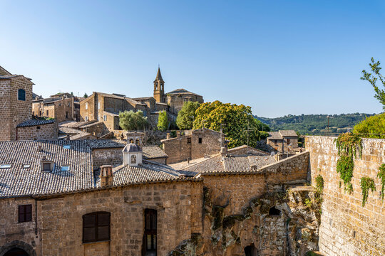 View of Orvieto's medieval historic centre along Strada di Porta Romana, featuring narrow streets, historic stone buildings and traditional urban architecture, Orvieto, Umbria, Italy