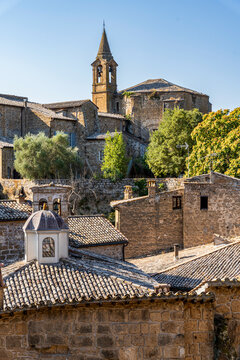 View from Via Malabranca over the medieval centre of Orvieto, with the bell tower of the Church of San Giovanni Evangelista visible among the historic buildings in the distance, Orvieto, Umbria, Italy