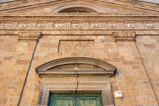 Detail of a visible crack in the masonry of the Church of Sant'Angelo facade along Corso Cavour, highlighting the weathering of historic stone architecture, Orvieto, Umbria, Italy