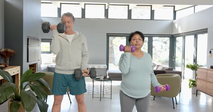 Lifestyle videos indoor of people doing activities at office, exercising with dumbbells, senior coup