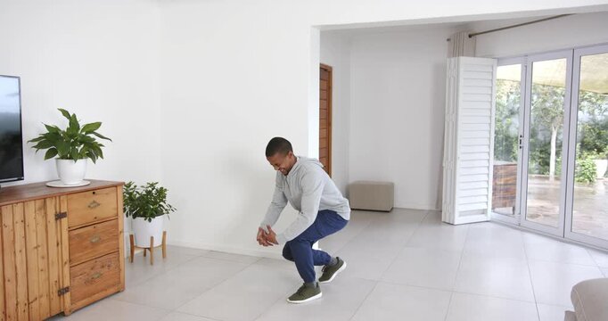 High speed photography for dynamic scenes, walking indoors, man smiling and holding smartphone in mo