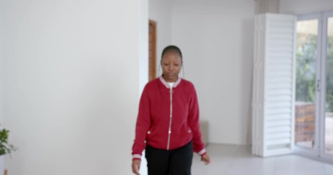 High speed photography for dynamic scenes, wearing red jacket, woman looking down thoughtfully