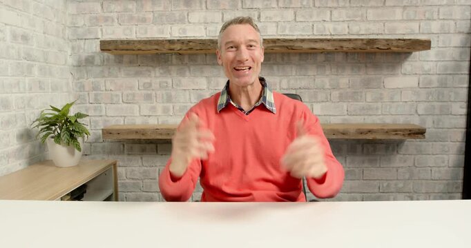 Close up of people talking to the camera, smiling businessman sitting at desk in office