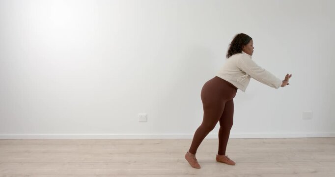 High speed photography for dynamic scenes, Exercising indoors, woman performing squat in fitness att