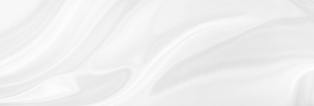 White gray satin texture that is white silver fabric silk panorama background with beautiful soft blur pattern natural.