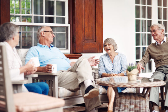 Break, friends and talking with old people on patio of retirement home for community support. Conversation, gossip and relax with group of seniors in backyard together for bonding or wellness
