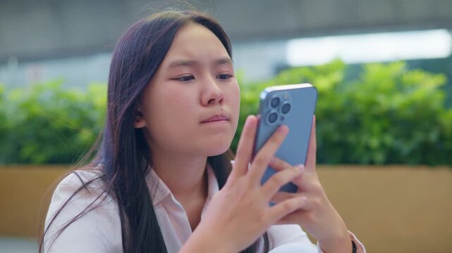 anxious worried teen girl with her smartphone as a conceptual footage for cyberbullying social media trauma, teenager mental health crisis, depression and panic attack