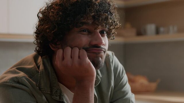 Close up thoughtful ethnic Indian man thinking idea at home kitchen Arabian male freelancer worried businessman searching solution deep in thought planning creative decision dreaming pondering problem