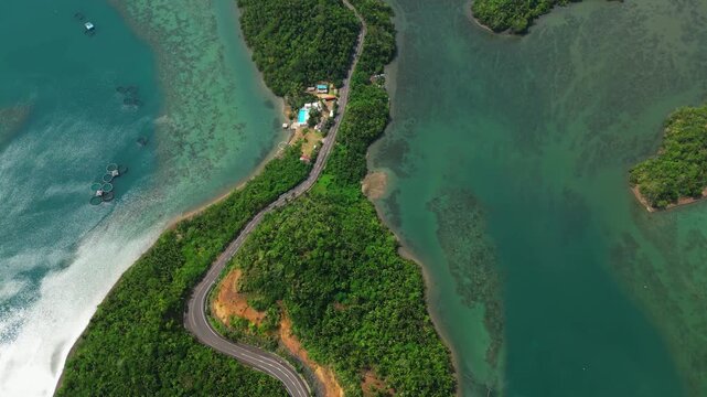 Overhead drone view of the Sula Bridge area on Cagraray Island, revealing Angel's Corner, Misibis Road and a vivid blue tropical lagoon under sunny skies.