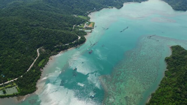 Scenic drone footage looking down over Sula Bridge and Angel's Corner, highlighting the winding Misibis Road and intensely blue coastal lagoon of Cagraray, Albay.
