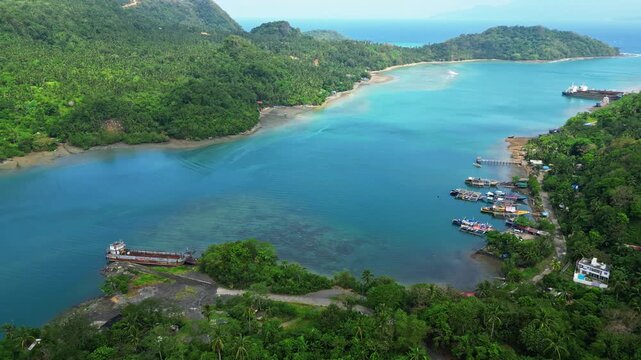 Wide aerial view from Sula Angling Spot showing a wrecked tanker in the blue coastal waters of Cagraray Island, with lush tropical scenery and surrounding coastline revealed from above.