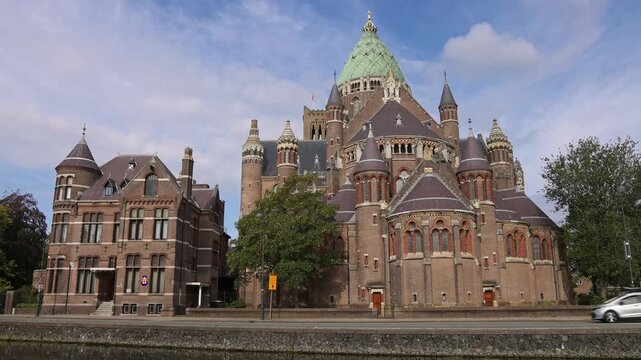 Exterior view of the majestic Cathedral Basiliek Sint Bavo along the canal road in Haarlem, Netherlands on 16 August 2026.