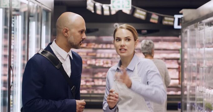 Supermarket, store clerk and man with help for groceries and service with consumer support. Question, guidance and people for customer experience, direction or point in aisle for shopping assistance