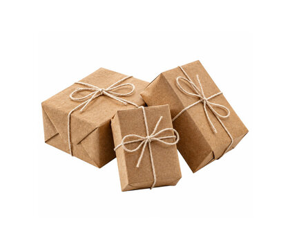 Three brown kraft paper gift boxes tied with twine bow isolated on white background