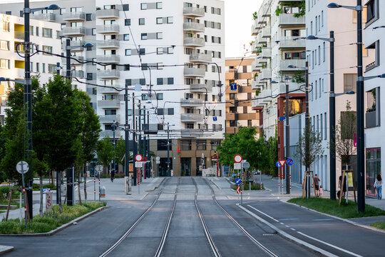 Broad tram street framed by modern housing in Nordbahnviertel Vienna Austria showing urban mobility and residential development in a new city district