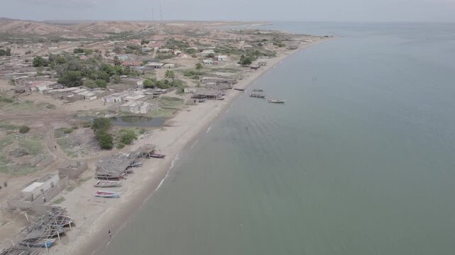 Forward Aerial View Along Araya Beach and Coastal Settlement