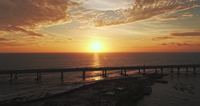 4k aerial view of Mumbai Sea link during sunset in Monsoon. Golden hour view of the Arabian Sea with cars running on the bridge. 