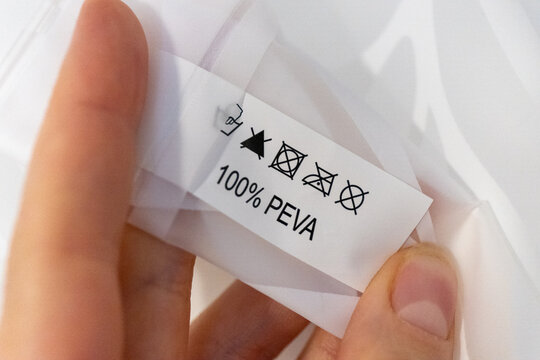 Close-up of a care label with washing symbols on 100 percent PEVA fabric