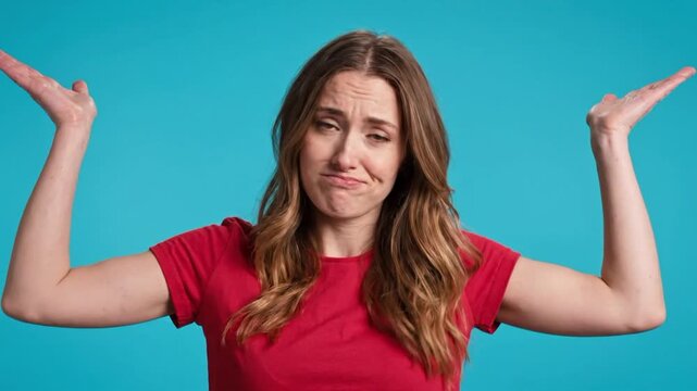 Clueless woman portrait with uncertain gesture against a blue background