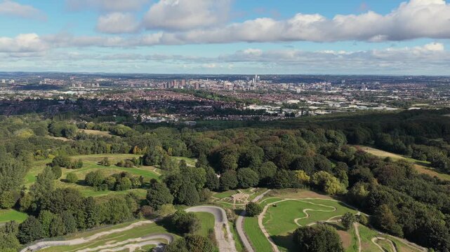 Aerial video looking north across the winding mountain bike trails, pump tracks, and extensive woodland of Middleton Park towards