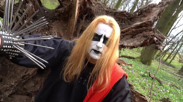 Black metal musician corpse paint in the forest